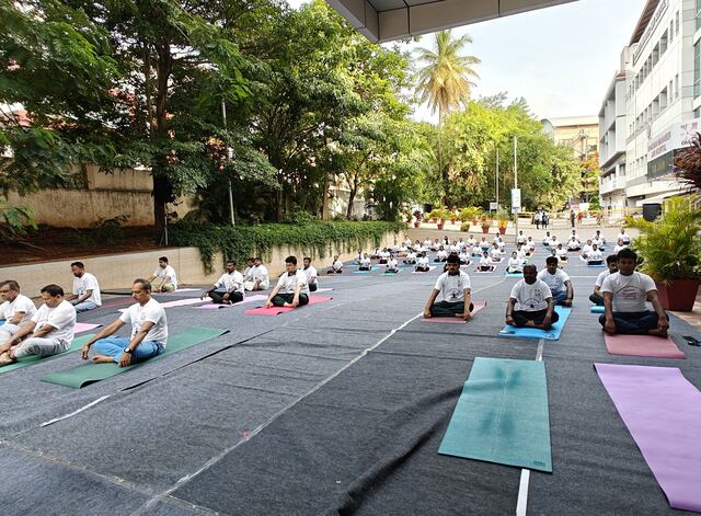 Participants seated in meditation pose on mats
